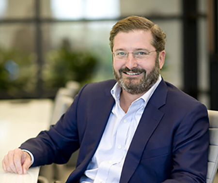 Richard W. Courts IV seated at conference table