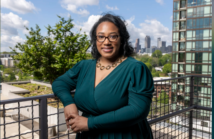 Maranie Brown poses on apartment balcony.