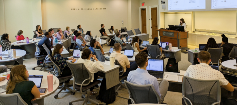 students in college classroom with tiered seating