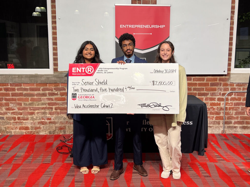 Jiya Patel, from left, Kareem Elfoulie and Halle Greenbaum pose with a giant prize check