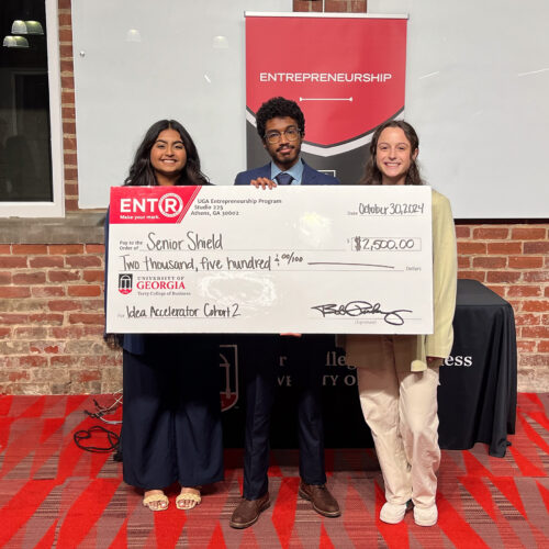 Jiya Patel, from left, Kareem Elfoulie and Halle Greenbaum pose with a giant prize check