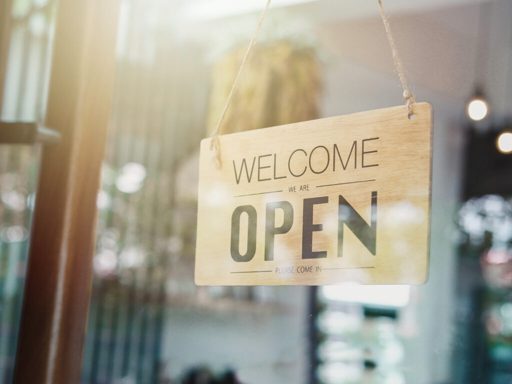 open sign in the window of a small shop