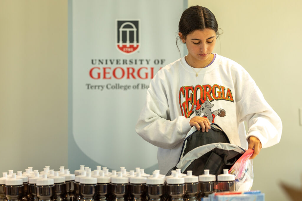 Terry Student packs a backpack to be distributed to a person living without a home