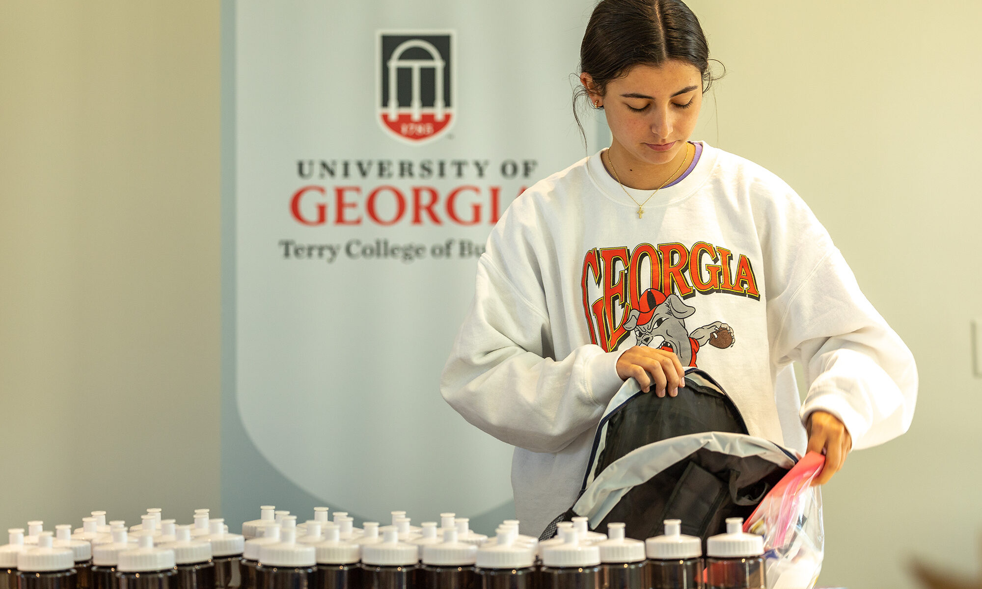 Terry Student packs a backpack to be distributed to a person living without a home