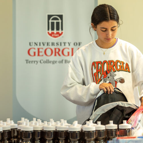 Terry Student packs a backpack to be distributed to a person living without a home