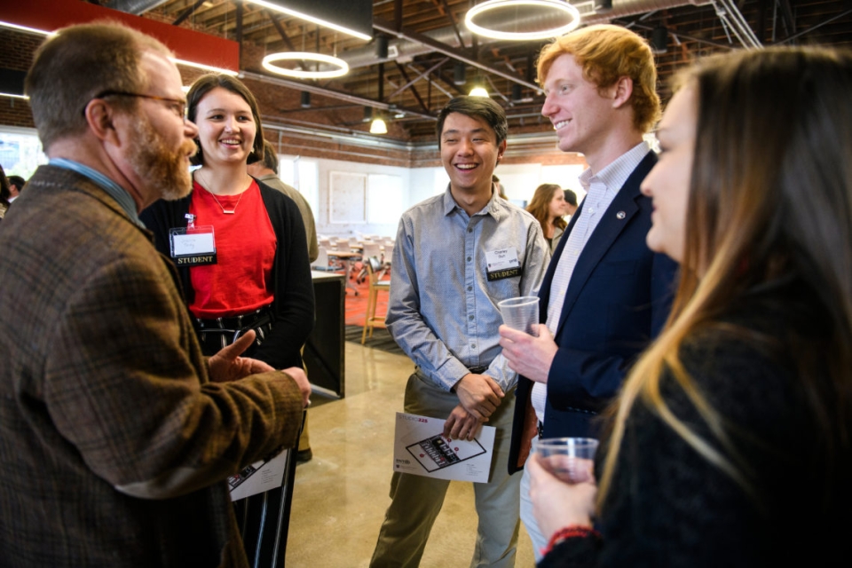 Students discuss the new entrepreneurial space in Studio 225 during Tuesday’s opening.
