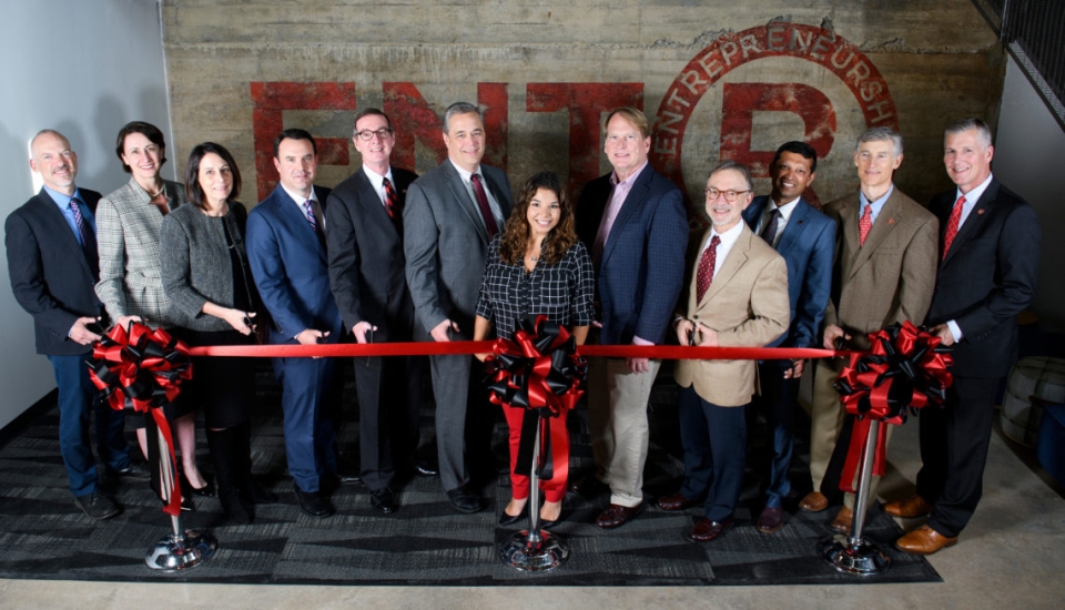 Special guests prepare to cut the ribbon marking the opening of Studio 225. 