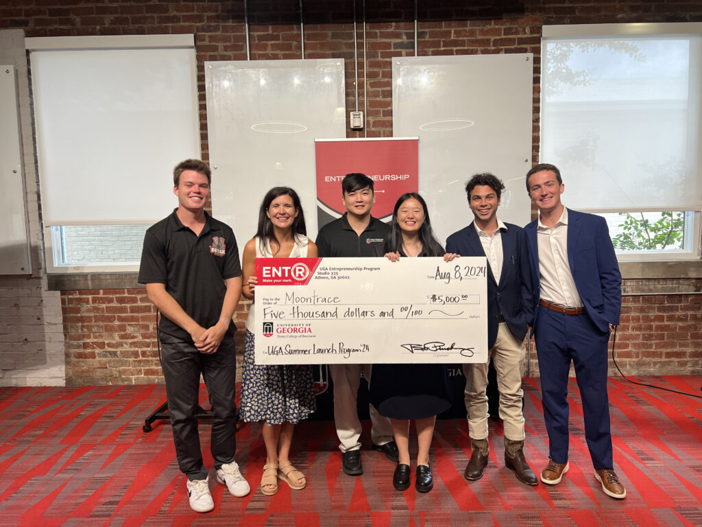 Summer Launch participants, from left, Jack TerHaar, UGA lecturer Cali Brutz, Alex Luu, Jasing Yang, Caleb O'Neil and Landon Stone pose with a giant prize check made out to Yang's company Moontrace.