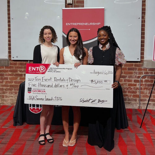 Moren Wallon, far left, and Jane Odum, far right, pose with Tenley Pelissier who holds a novelty prize check for $5000