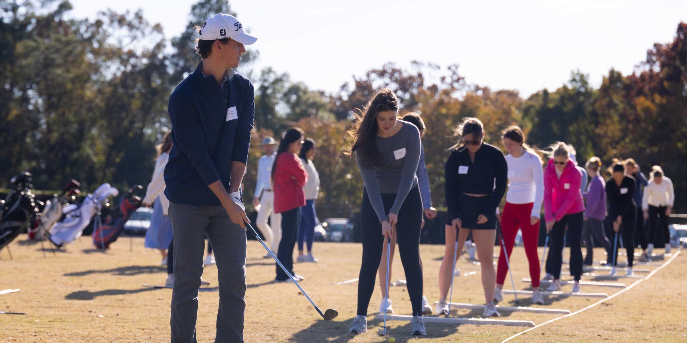 Students lined up at a driving range