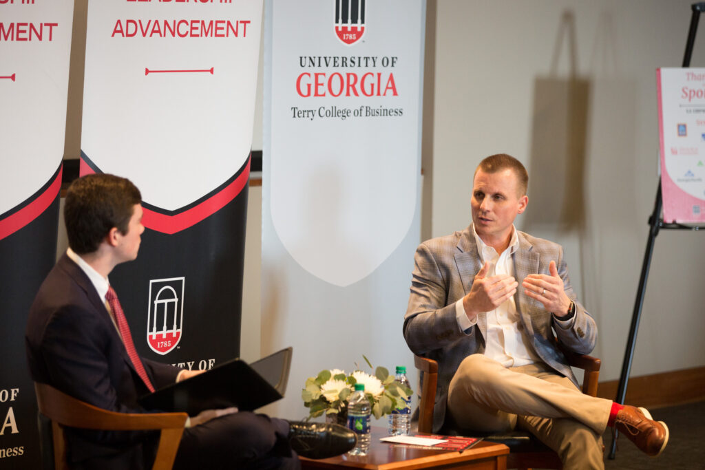 Mark Spain speaks to an interviewer during a Terry Leadership Speaker Series event.