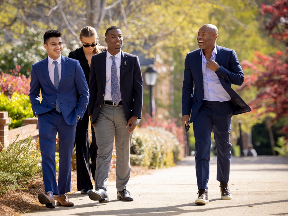 Tope Awotona walking with students