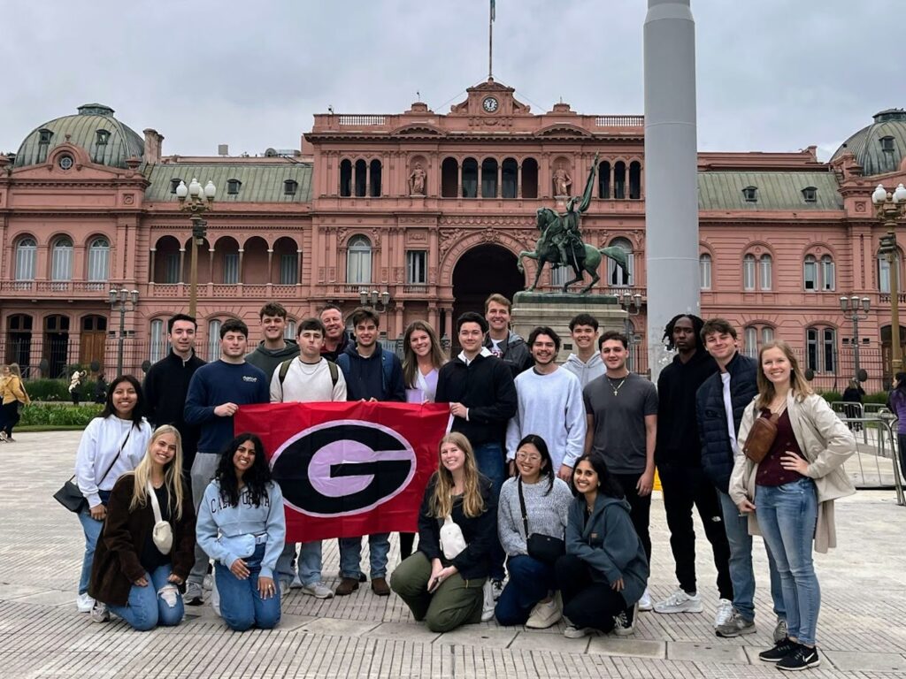 Students standing in front of historic Casa Rosado during a Terry College Study Away in Argentina