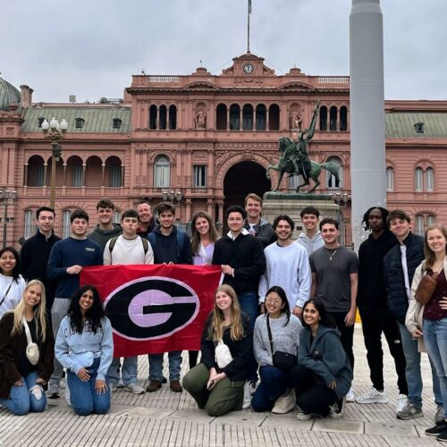 Students standing in front of historic Casa Rosado during a Terry College Study Away in Argentina