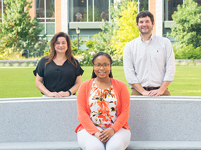 Ph.D. candidate Edwyna Hill (center) with management professors Marie Mitchell and Fadel Matta.