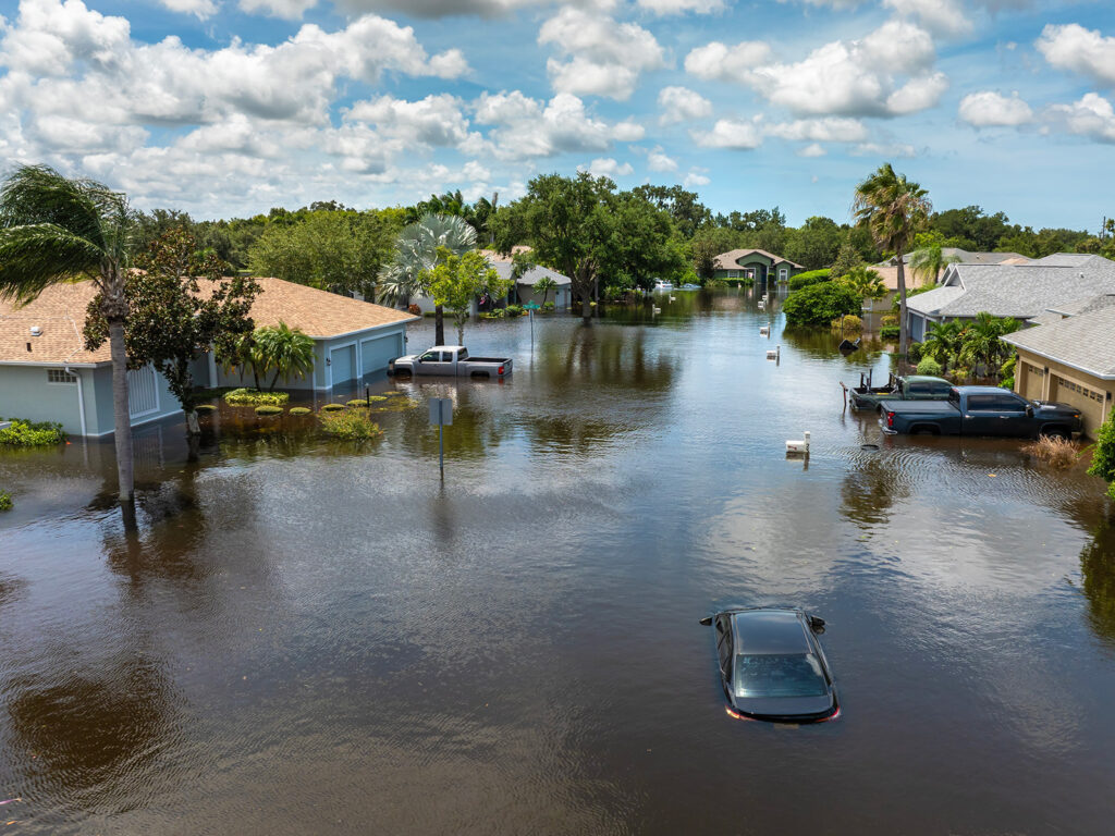 An aerial shot of an hurricane-flooded neighborhood in florida hurricane damage and property insurance rates