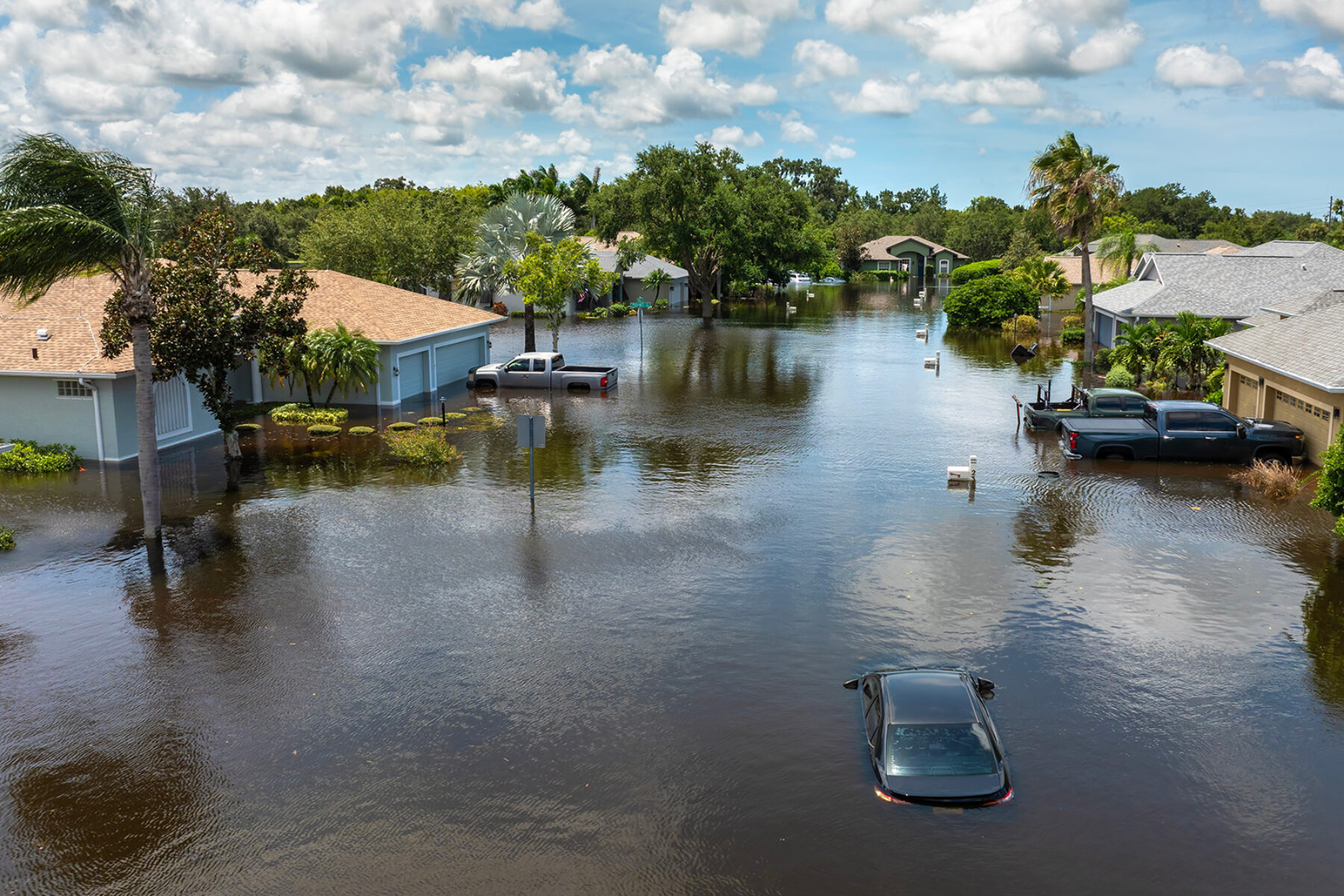 An aerial shot of an hurricane-flooded neighborhood in florida hurricane damage and property insurance rates