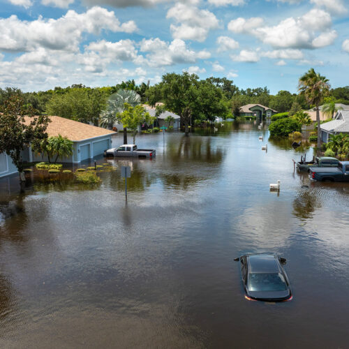 An aerial shot of an hurricane-flooded neighborhood in florida hurricane damage and property insurance rates
