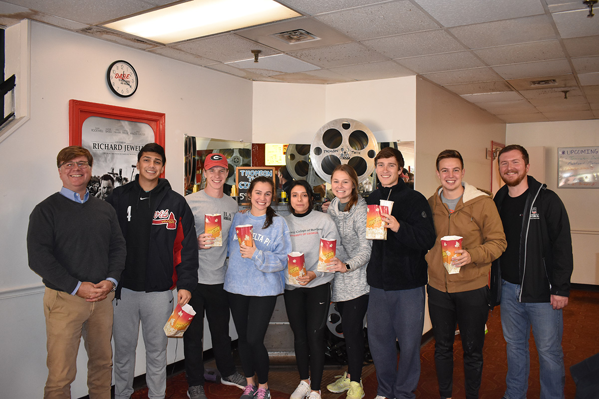 Group photo of students and owner
