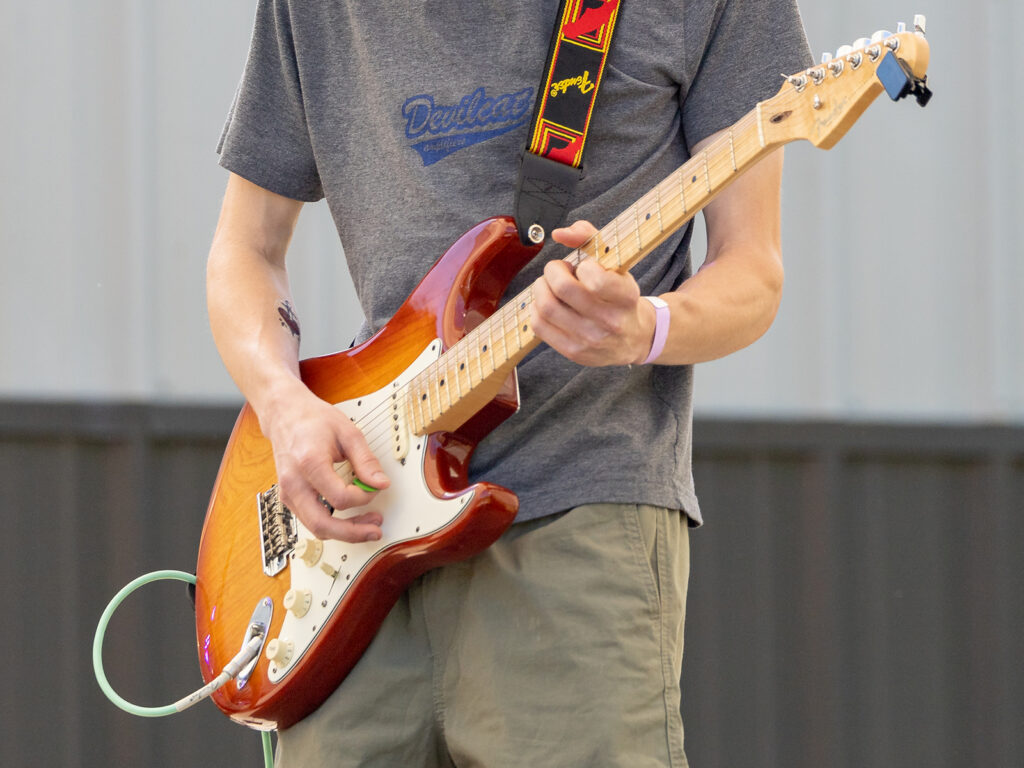 Close up of a man playing guitar at the Terry College Music Business Beats and Brews Festival