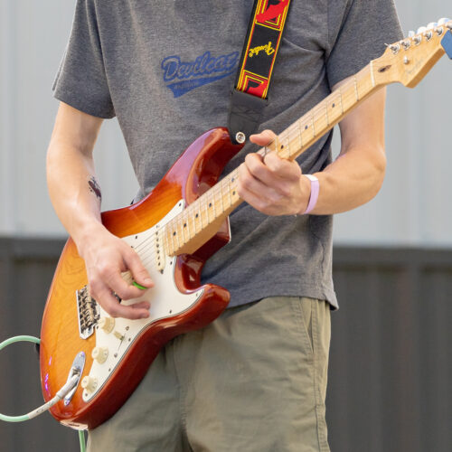 Close up of a man playing guitar at the Terry College Music Business Beats and Brews Festival