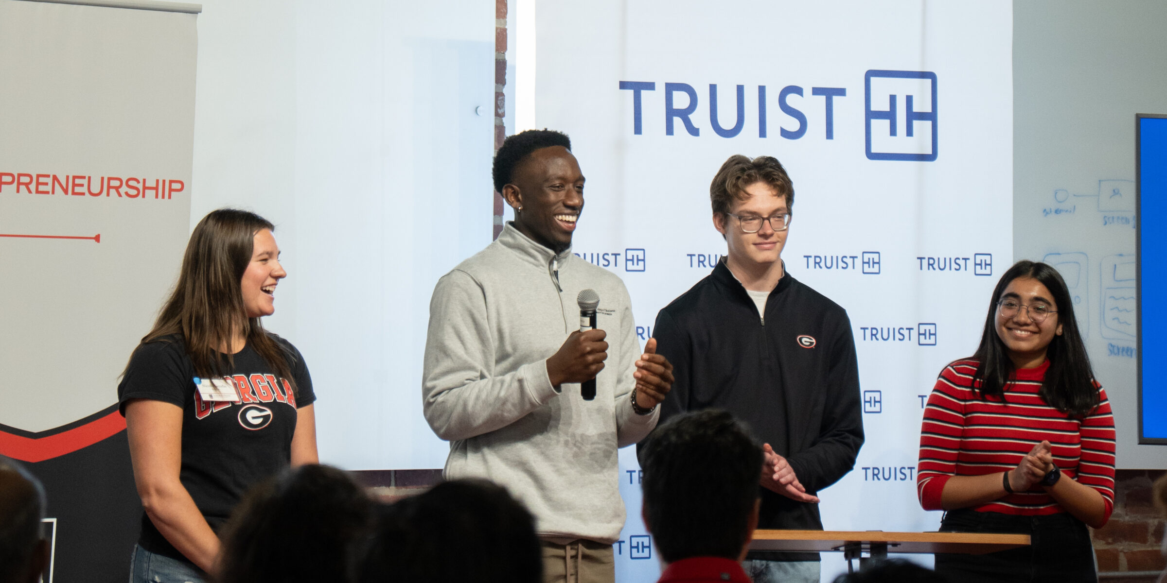 Students pitch a customer service solution to Truist executives during an immersive learning experience at Studio 225