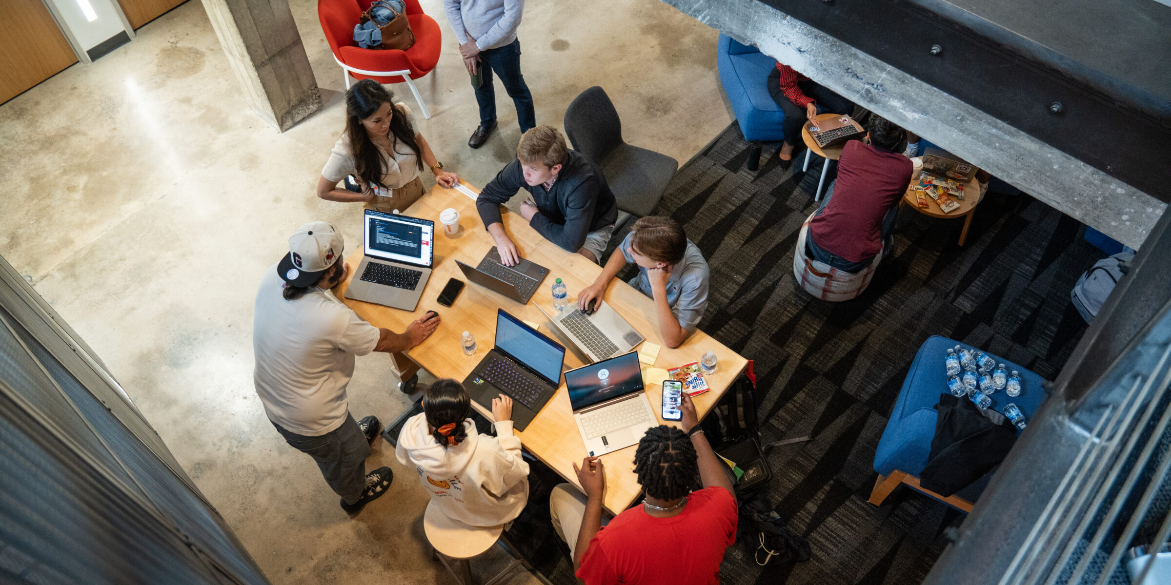 Students work around a table at Studio 225, photo shot from above.