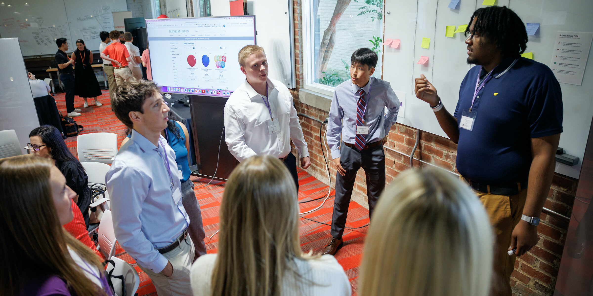 Terry students work at a white board in Studio 225 during the Truist Immersive Learning Experience.