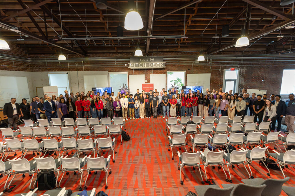 UGA-EXP-D2-group-2 A large group of students gather for a group photo at the immersive learning experience created and hosted by Truist.