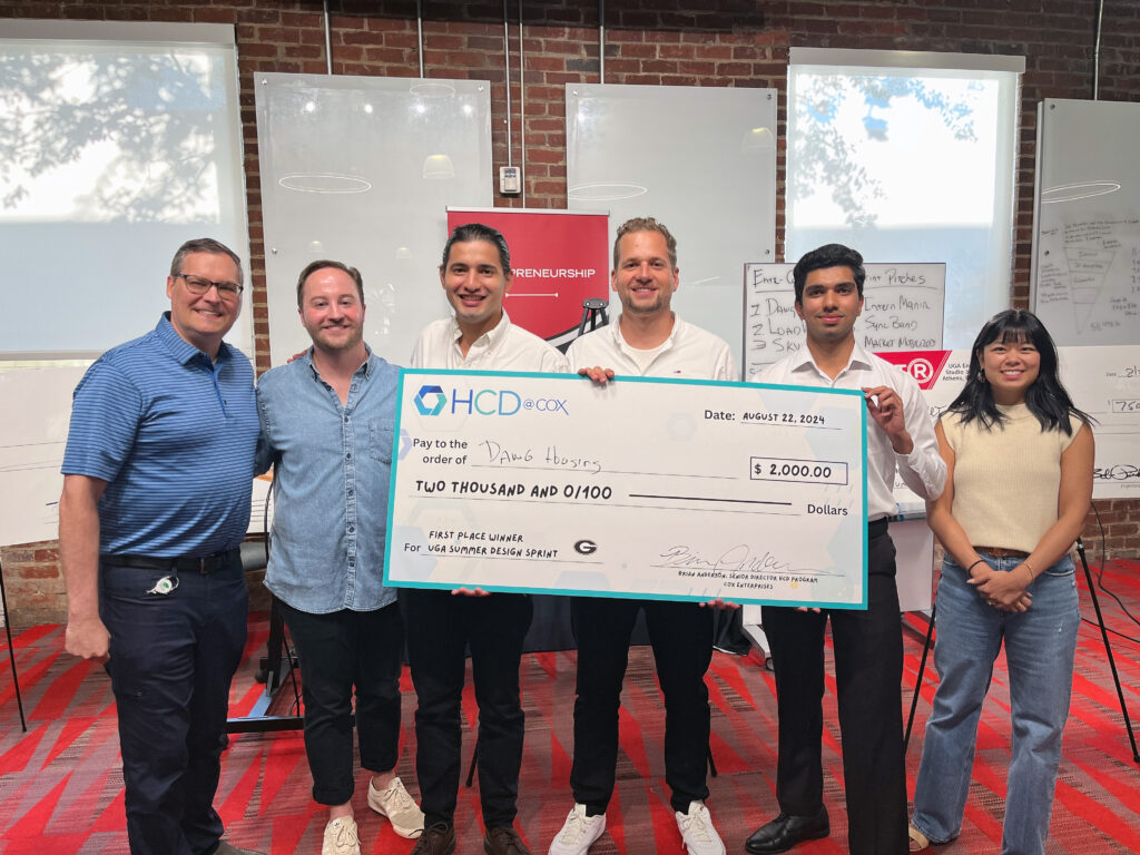 Cox Enterprises' Brian Anderson, Cole Mokry and Amy Lin congratulate Dawg House app creators Emilio Romero, Manuel Blaser and Muneeb Malik .