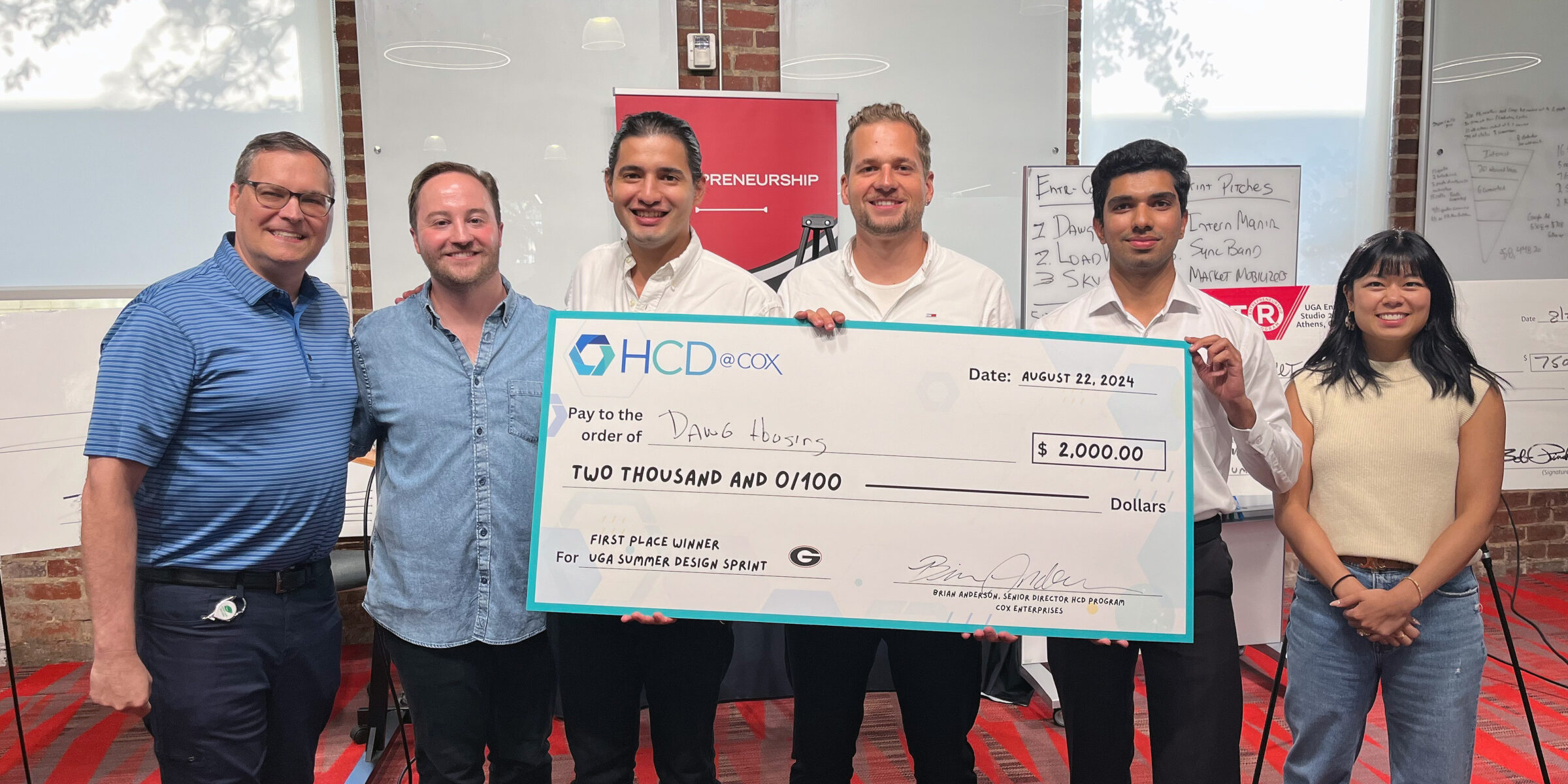 Cox Enterprises' Brian Anderson, Cole Mokry and Amy Lin congratulate Dawg House app creators Emilio Romero, Manuel Blaser and Muneeb Malik .