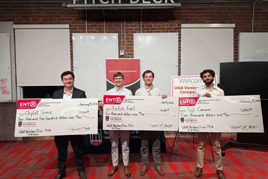 Winners of the 2026 Venture Prize Competition post with their large checks.
