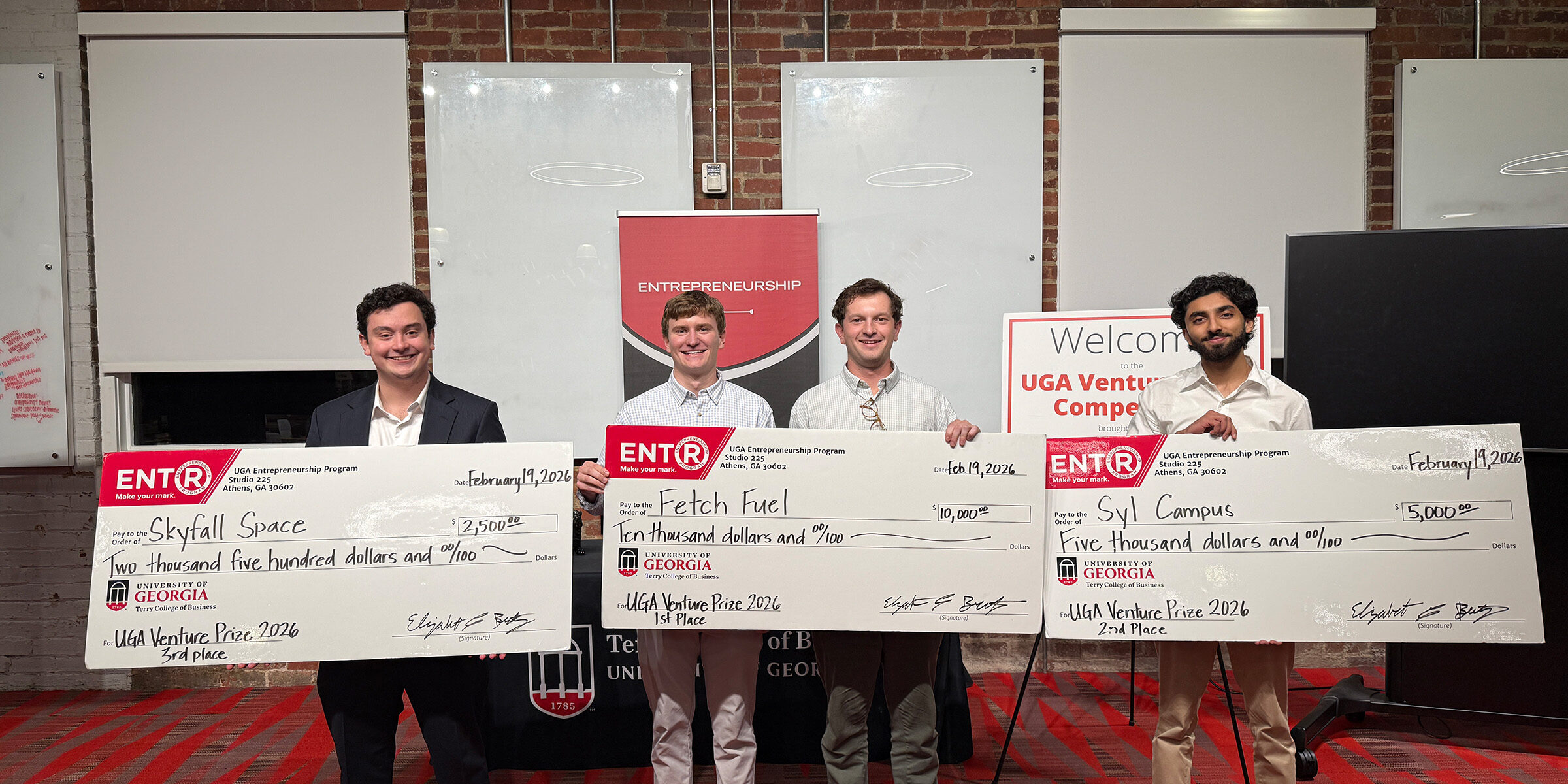 Winners of the 2026 Venture Prize Competition post with their large checks.