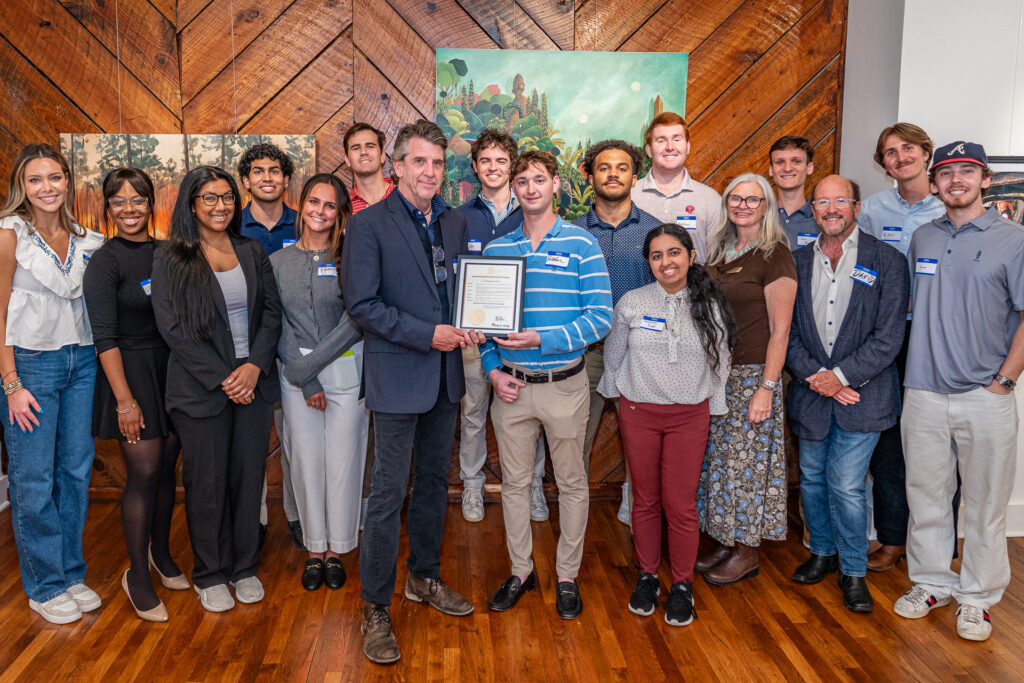 Winterville Mayor Dodd Ferrelle poses with a proclamation from Governor Brian Kemp and David Sutherland's creative economies class.