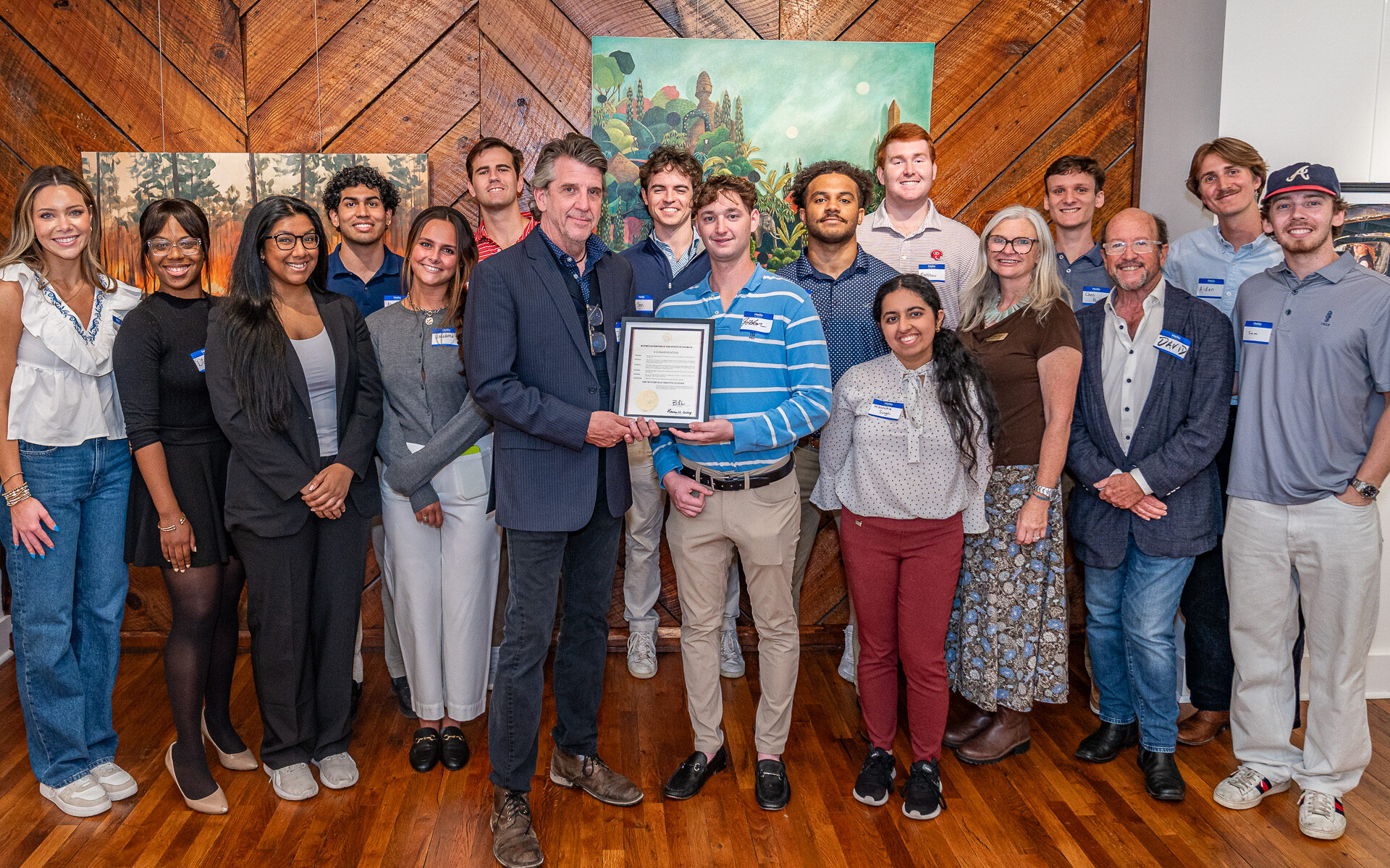Winterville Mayor Dodd Ferrelle poses with a proclamation from Governor Brian Kemp and David Sutherland's creative economies class.
