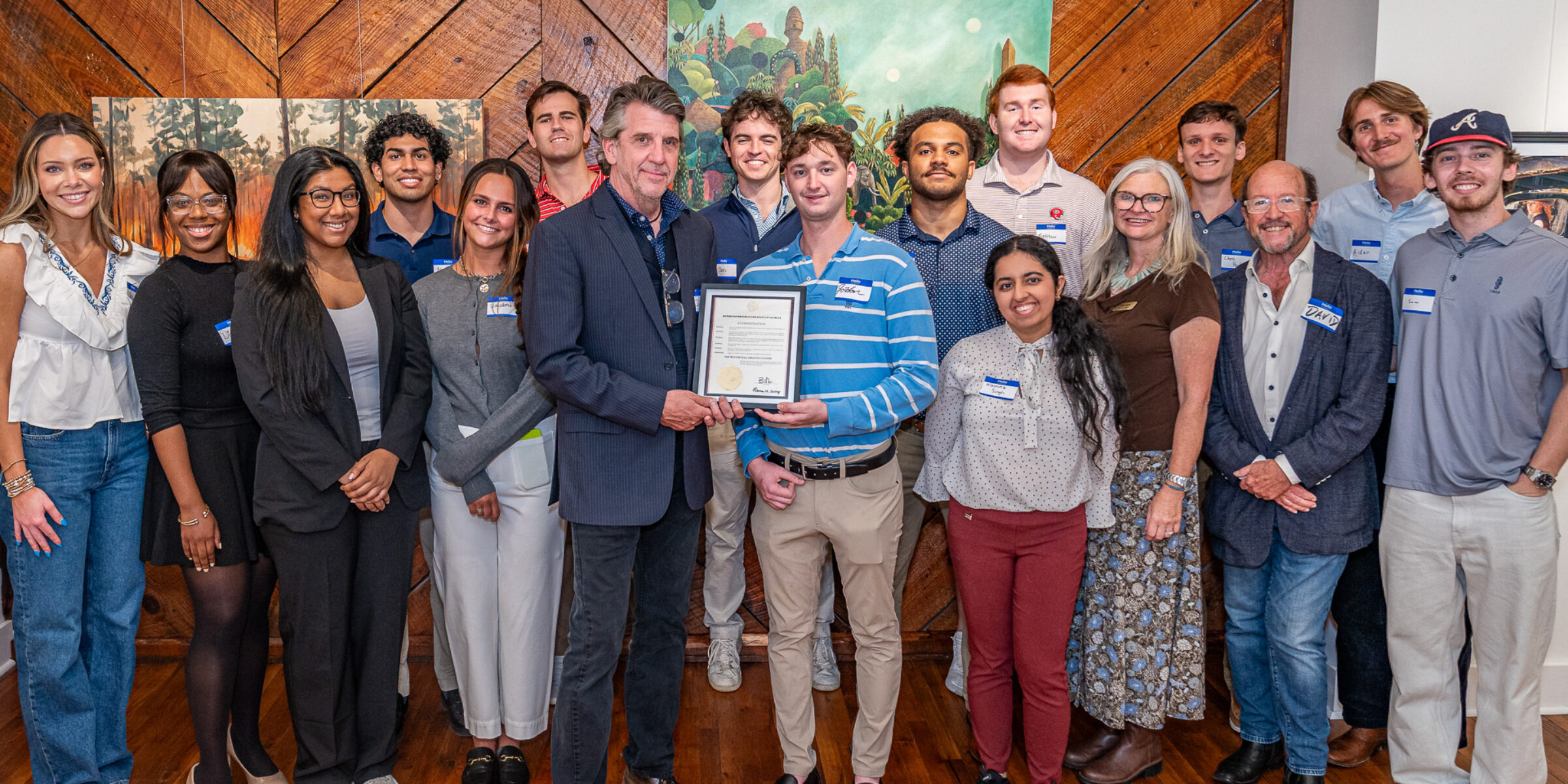Winterville Mayor Dodd Ferrelle poses with a proclamation from Governor Brian Kemp and David Sutherland's creative economies class.