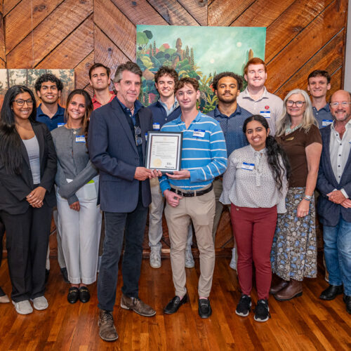 Winterville Mayor Dodd Ferrelle poses with a proclamation from Governor Brian Kemp and David Sutherland's creative economies class.