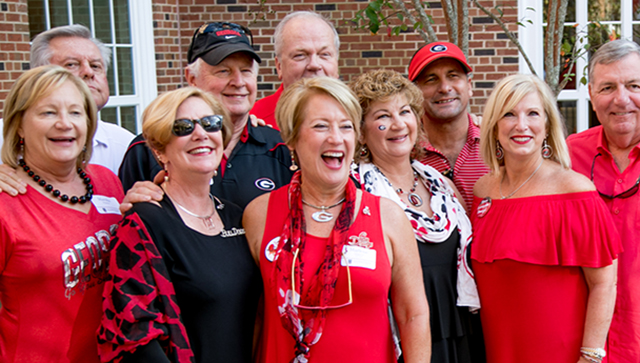 People pose for a picture in festive red colors