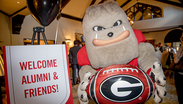 Hairy dog and a welcome alumni and friends sign