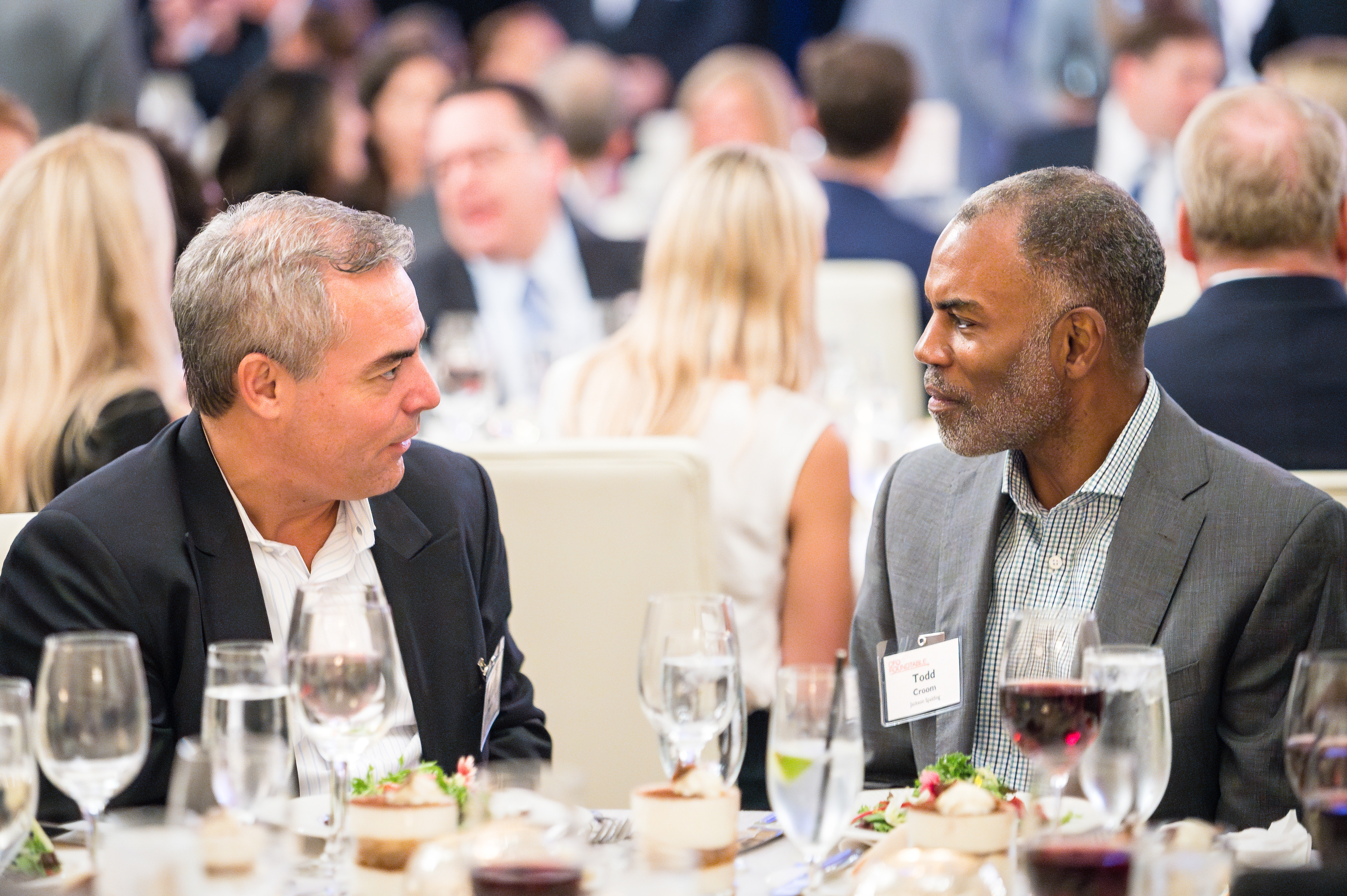 Two men talking with each other at dinner