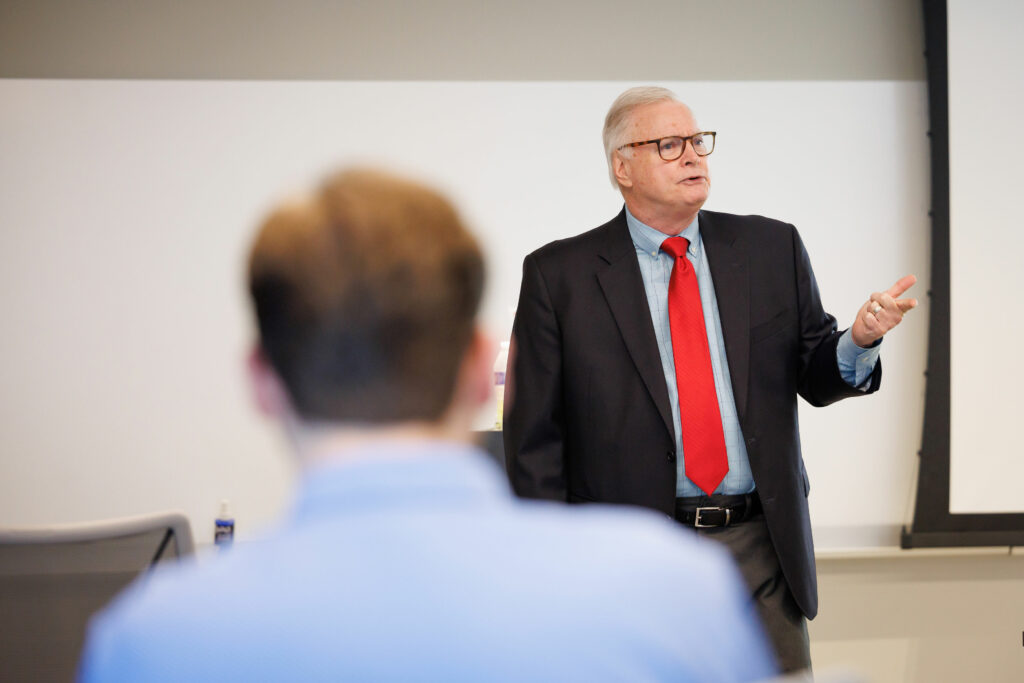 man presenting at front of classroom
