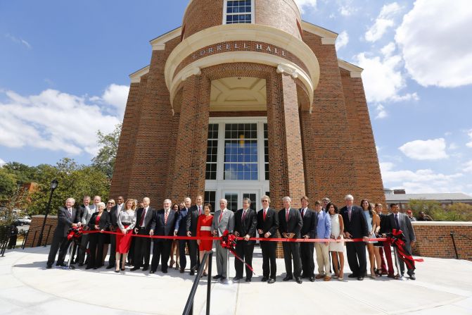 Terry College leaders stand in front of Correll Hall during a ribbon-cutting ceremony.