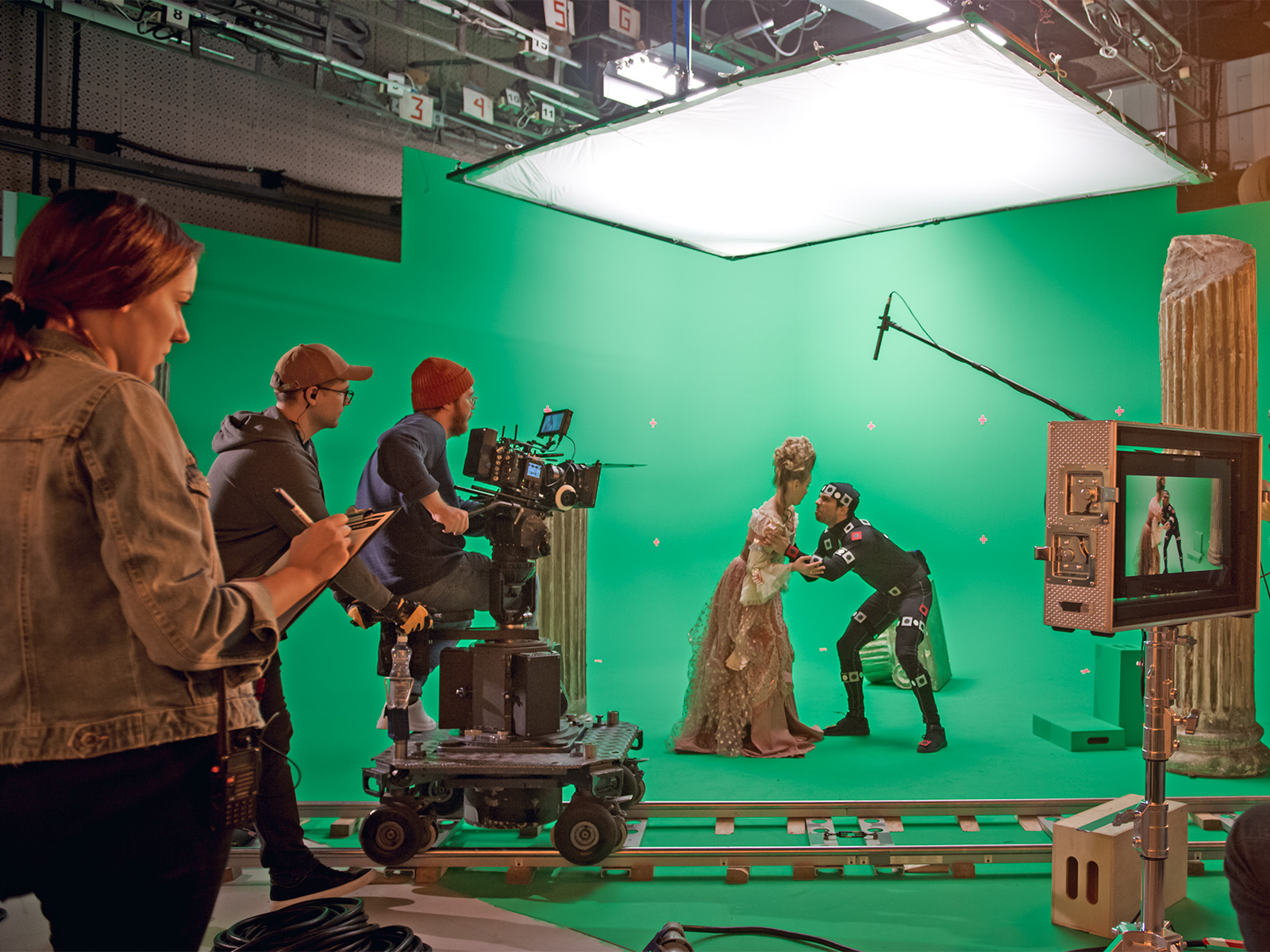 People working on a green screen movie set.