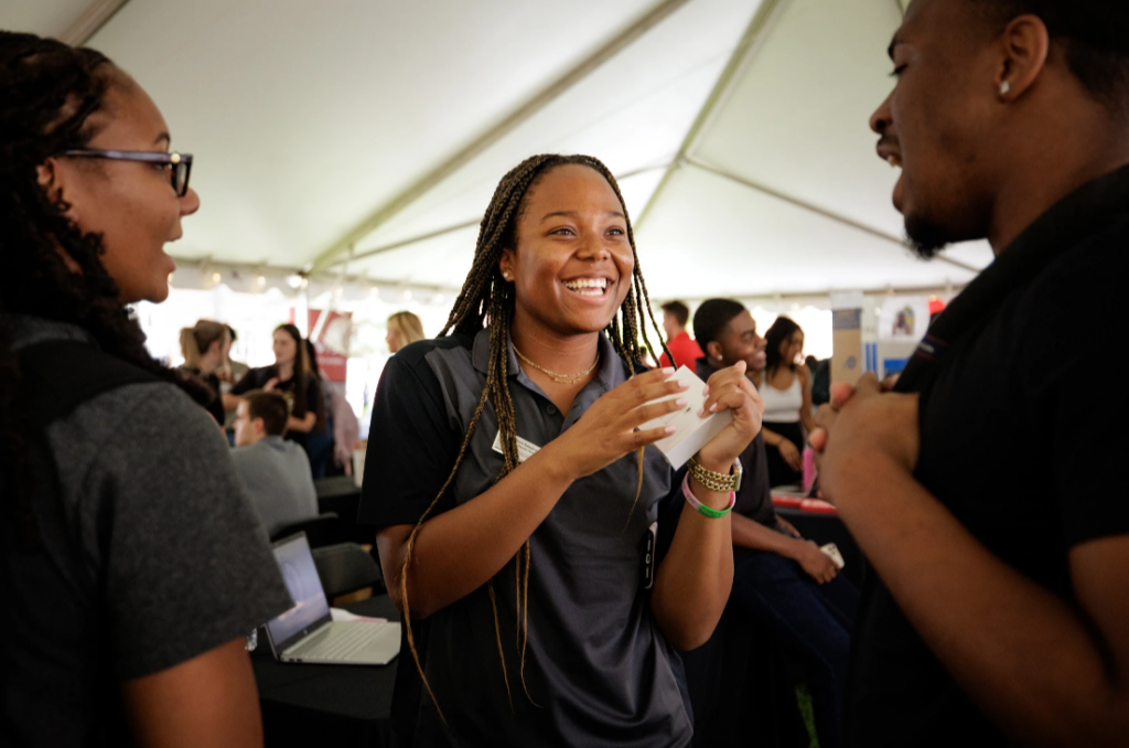 Diversity Fellows talking with students at Back To Business