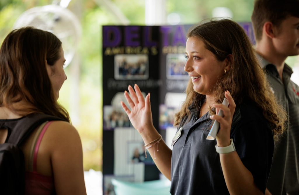 Diversity Fellow talking with student at Back To Business