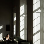 A Terry College student sitting on a couch reading in Casey Commons 