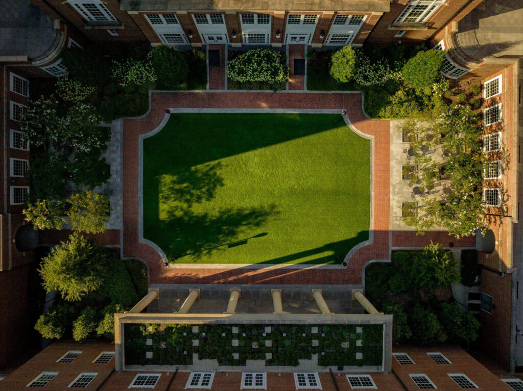 aerial photo of courtyard with trees casting shadows