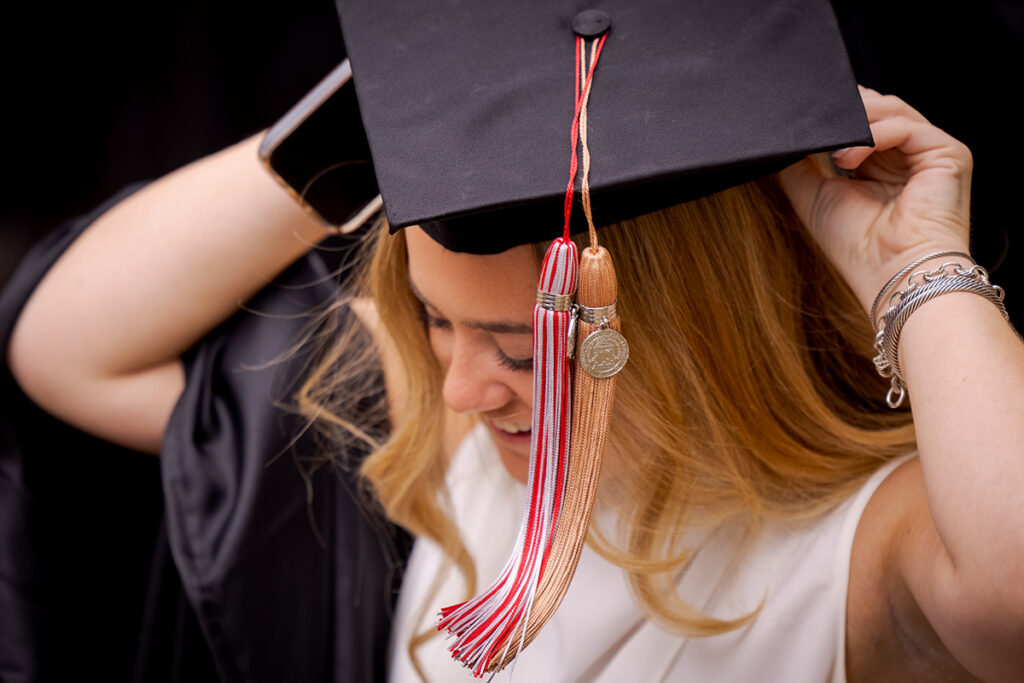 A female graduate adjusts her cap