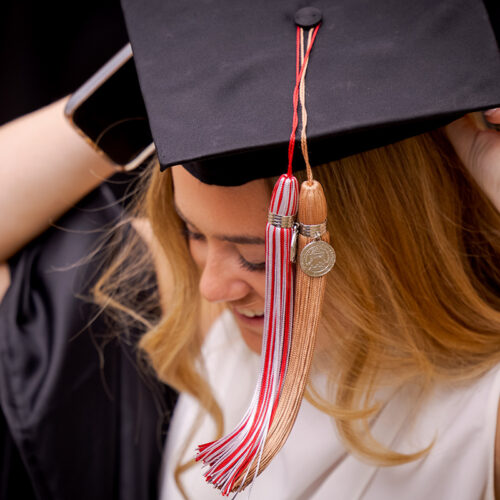 A female graduate adjusts her cap