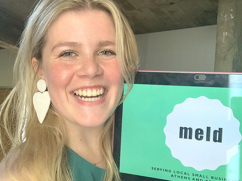 Sabrina Greco smiles with her Meld logo